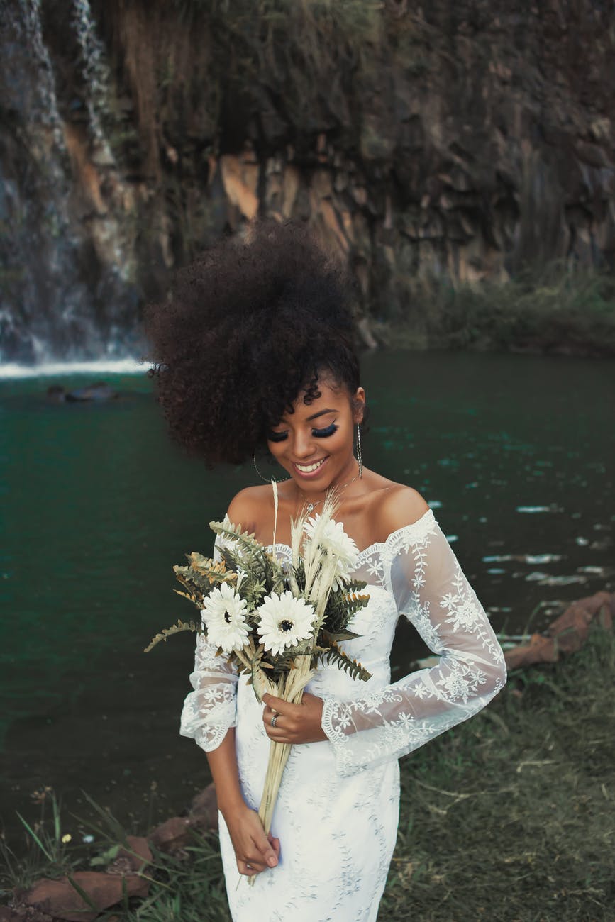 standing woman wearing white long sleeved dress